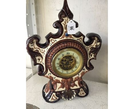 A Continental china cased mantle clock with visible movement.