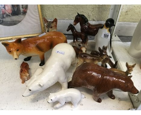 Twelve various china animal ornaments to include a large Poole Pottery Penguin.