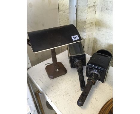A student's electric desk lamp together with a pair of coach lamps.
(R9)