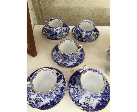 Five Royal Crown Derby bone china blue and white cups and saucers decorated in the Mikado pattern.