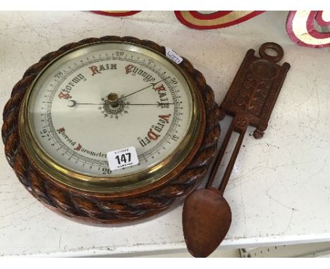 A late 19th century oak cased aneroid barometer.