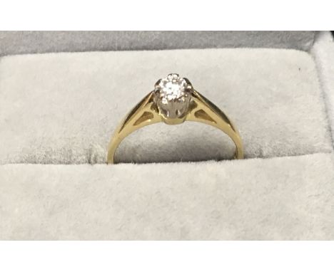 An 18ct gold ring set with a solitare diamond . (K).