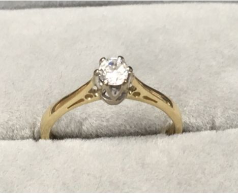 An 18ct gold ring set with a solitare diamond . (K).