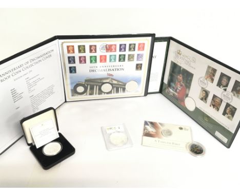 A collection of silver coins including the 50th anniversary of Decimalisation silver proof coin collection cover, The Queens 