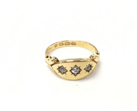 An 18ct gold gents ring set with three diamonds. Size K and 3.08g. Postage A