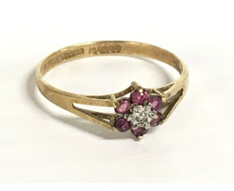 A 9 carat ruby and diamond set flower ring size Q, 1.25g. Postage category A