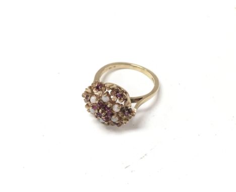 A 9ct gold ruby and Opal set cocktail style ring. Size O, Approx weight 4.1 grams.
