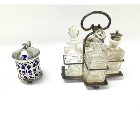 A Christofle mustard pot and silver spoon along with a silver plate cut glass condiment set in caddy
