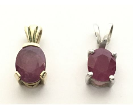 A 9ct white gold ruby pendant and a 9ct yellow gold ruby pendant. With certificates. Total weight 2g Postage category A