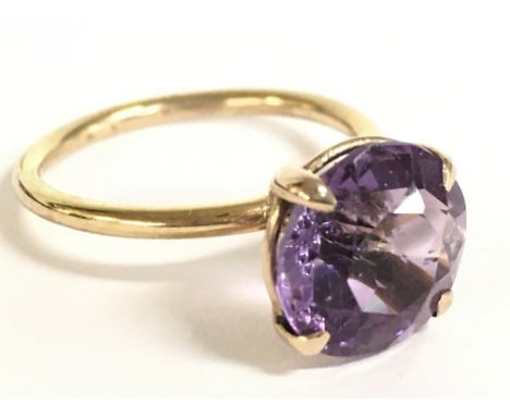 A 9 carat gold amethyst solitaire ring, 2.2g. Size K. Postage category a
