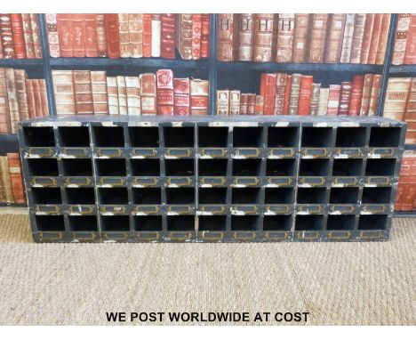 A vintage set of shopfitting / haberdashery / engineer's wooden cubby holes with brass ticket pockets, 44 sections (H46 x W14