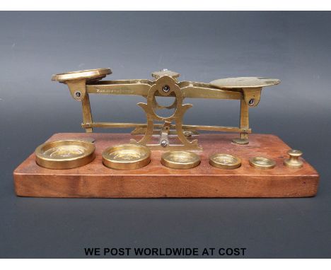 A set of Parkins & Gotto postage scales on wooden base with weights 