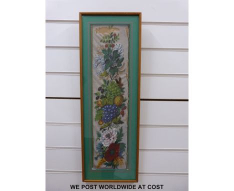 A framed bead tapestry with floral decoration