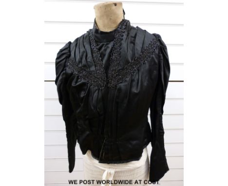 A black satin blouse with jet trimming and a set trimmed brocade cape with lace collar