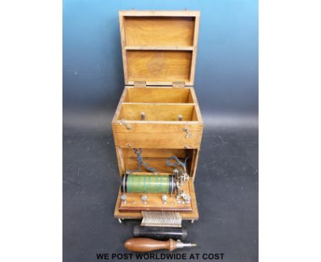 An early 20thC electrical therapy machine complete with comb and rod attachments, in wooden case