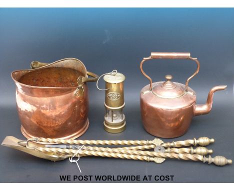 A copper coal scuttle, kettle, fire irons and a miner's lamp