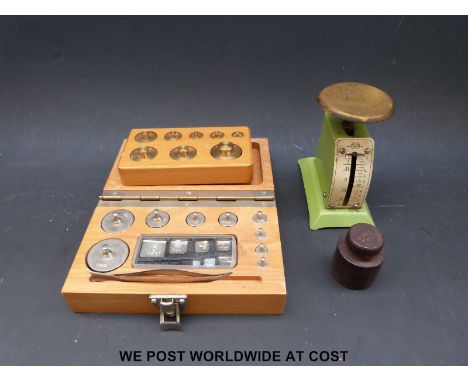 A vintage postal scale, two boxed sets of weights and a 200g weight