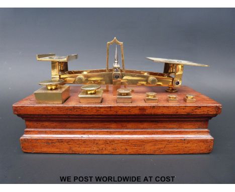A set of J & E Ratcliff postage scales on base with square tapering weights to front 