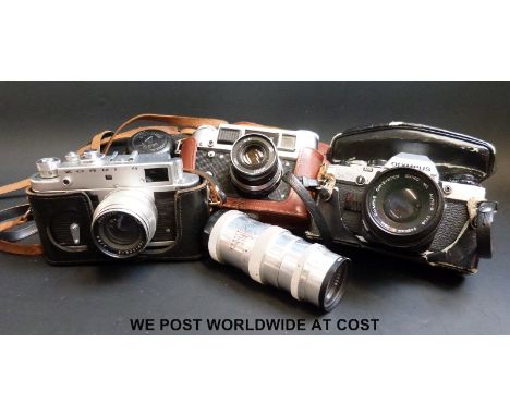 An Olympus OM10 SLR camera, Fed-4, Zorki -4 camera and a 135mm Russian screw type lens