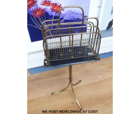 A brass magazine rack on tripod legs (H84 x W20cm)