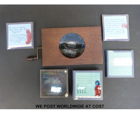 A mechanical magic lantern slide with a moving picture of fish together with a box of further slides 