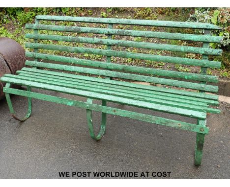 A wrought iron framed garden bench (length approximately 180cm)