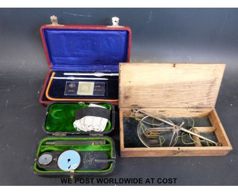 A cased early 20thC Morton's opthalmoscope with Ministry mark together with cased glass pharmaceutical scales and a haemacyto