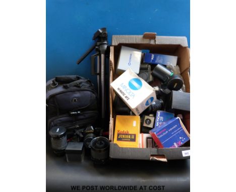 A Canon T90 camera in carry case with accessories, tripod and a collection of other vintage cameras and lenses etc