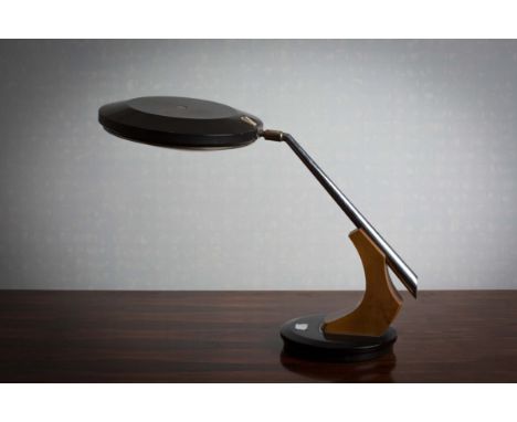 A 1960s EXECUTIVE LAMP, CONTINENTAL, the adjustable head with a chrome tubular support, on a circular swivel base, 46cm high