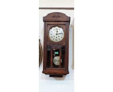 A 1930's oak cased wall clock with three train movement and Westminster chime on the quarter hours. 31½'' high