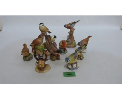Nine Royal Worcester birds and a Goebel Hummell figure of a young boy