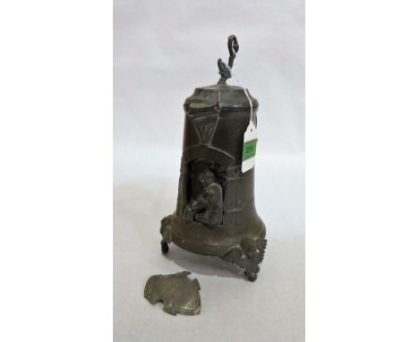 An antique German tankard, the body inset with a shoemaker at his shop window, the lid with dolphin finial and shield with ve
