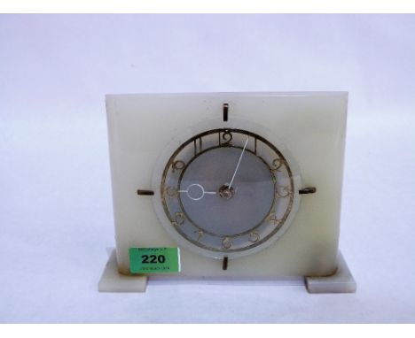 An Art Deco onyx cased mantle clock with fret cut chapter dial. 6'' high. Movement not running