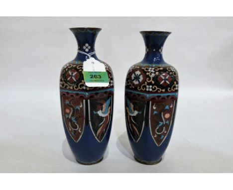 A pair of Japanese cloisonné enamel hexagonal vases, typically decorated with birds, dragons and foliage. 9½'' high. One with