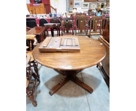 An Ercol dining table extending to 64½'' with folding extra leaf