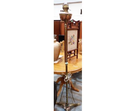 A Victorian wrought brass telescopic oil lamp standard on tripod support. Converted for electricity