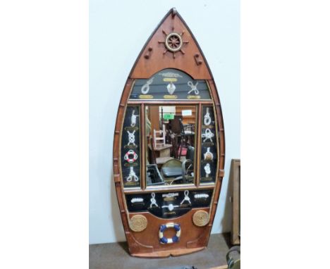 A marine glazed wall plaque in the form of a boat with display of sailor's knots and mirror plate. 39'' high