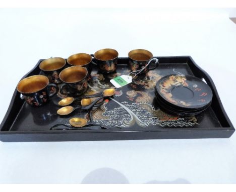 A Chinese papier-mache and lacquer tea service for six with tray decorated with flaming dragons