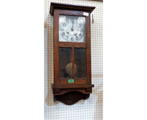 A 1930's oak cased wall clock with two train movement. Not running. 28'' high