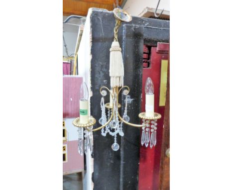 A gilt brass three light chandelier hung with pendants and prismatic drops