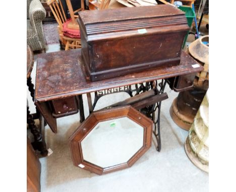 A trestle iron based sewing machine, an oak octagonal mirror, an open bookcase and an oak firescreen