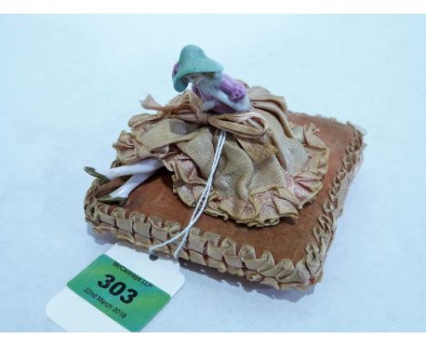 An early 20th century pin cushion doll, the cushion 4'' wide