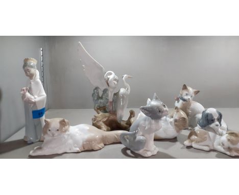 A group of five Nao models of cats, dogs and herons together with two Lladro models of a young boy wearing a crown and a kitt