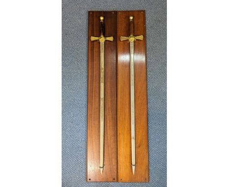 A pair of Wilkinson Sword commemorative swords, blades etched with greyhounds and to brass cross guard, on presentation wall 