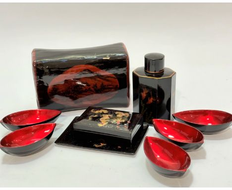 A Japanese lacquered pillow with panel depicting mountain and cottages, (14 x 10 x 22), a lacquered octagonal tea caddy decor