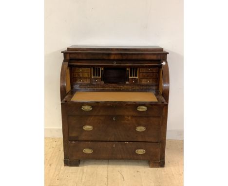 A Continental 19th century mahogany cylinder writing bureau, the caddy top over fitted interior, having pull out writing surf