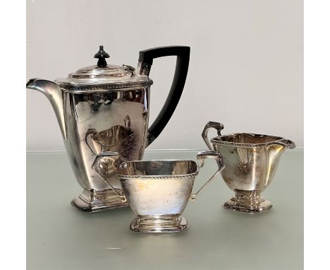 An Epns three piece tea service of rectangular tapered form with black handle to side and knop, (19cm), on stepped base