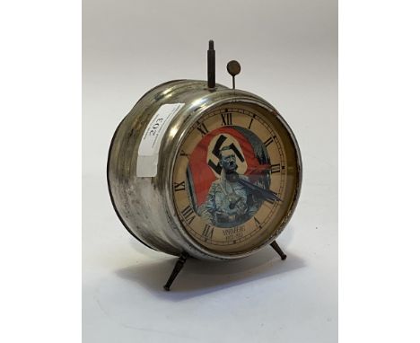 A German Nurnburg souvenir alarm clock, circular steel case with paper face depicting Adolf Hitler, NURNBERG 1923-1933.  Miss