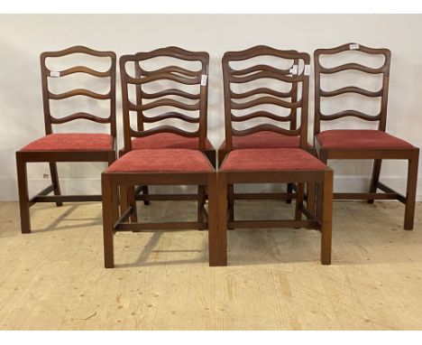 A set of six 20th century Georgian style mahogany ladder back dining chairs, with drop in seat pads, raised on square chamfer