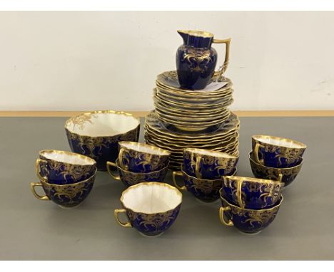 An Aynsley china blue and gilt part tea service, comprising 11 cups, 12 saucers, 12 side plate, milk jug and bowl